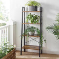 The Plant Bookcase Living Room Organizer Rack features a tall, black metal frame with wooden shelves, adorned with potted pla