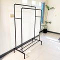 Metal Clothes Stand by Metallics Home featuring a sturdy frame with side storage shelves and hooks, set against a bright inte