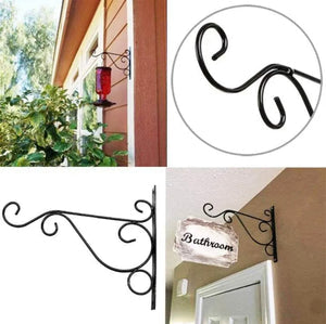 Wall Mounted Flower Pot Hanger Stand by Metallics Home features a decorative black metal design for hanging pots or signs.