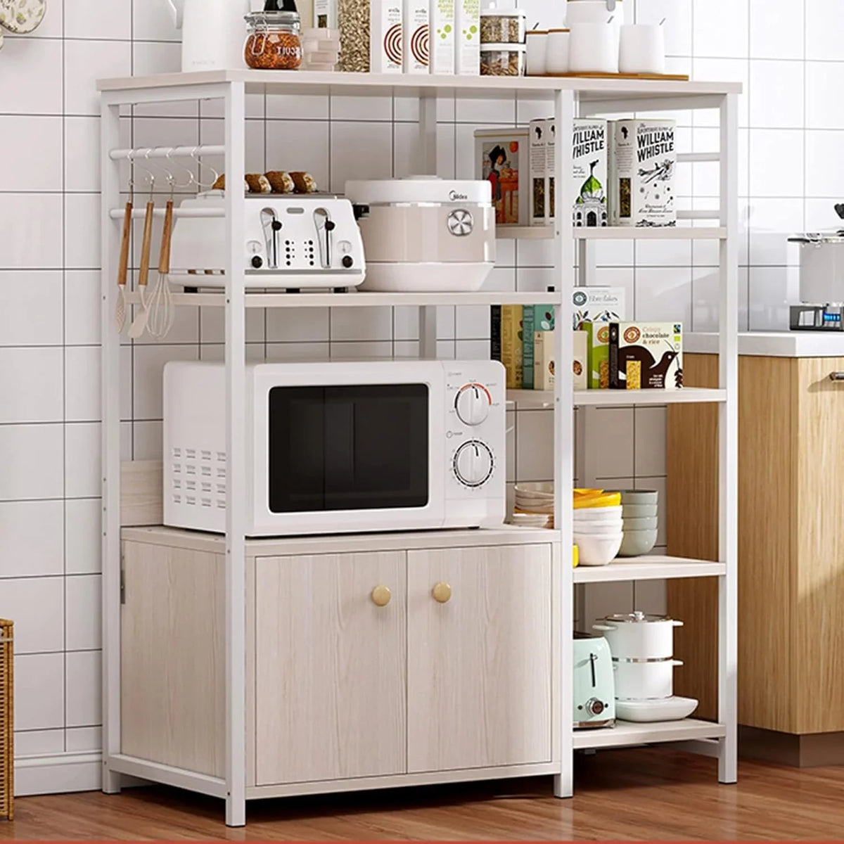 Larakol Kitchen Bakers Oven Rack by Metallics Home features a multi-tiered design with shelves, a microwave, and storage cabi