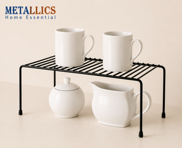 Inside Cabinet Desktop Shelf by Metallics Home features a black metal frame with a slatted design, holding three white mugs a