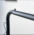 Close-up of the Dual Pole Metal Clothes Stand by Metallics Home, showcasing the sleek black metal frame and design details.
