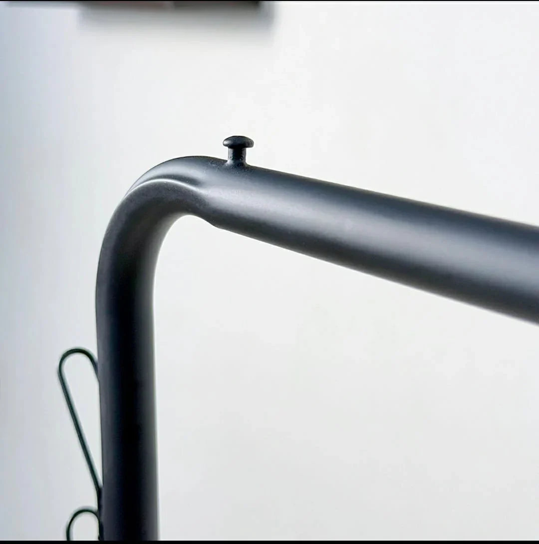 Close-up of the Dual Pole Metal Clothes Stand by Metallics Home, showcasing the sleek black metal frame and design details.