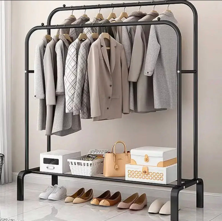 Metal Clothes Stand by Metallics Home featuring hanging space for coats, side shelves, hooks, and shoes below.