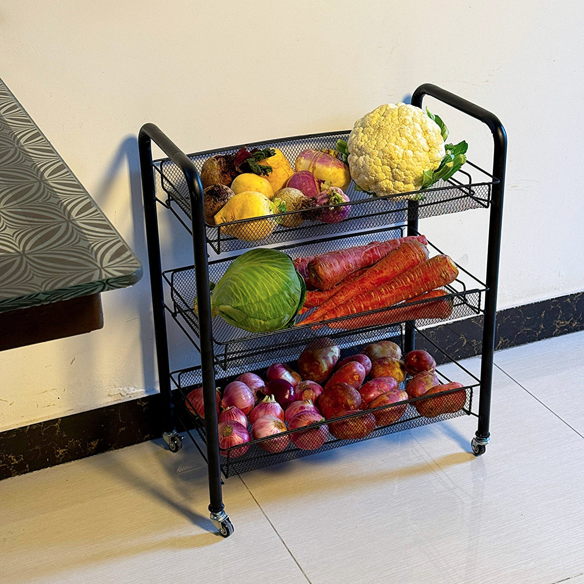 Multipurpose Foldable Kitchen Trolley by Metallics Home with four mesh shelves, holding various fruits and vegetables.