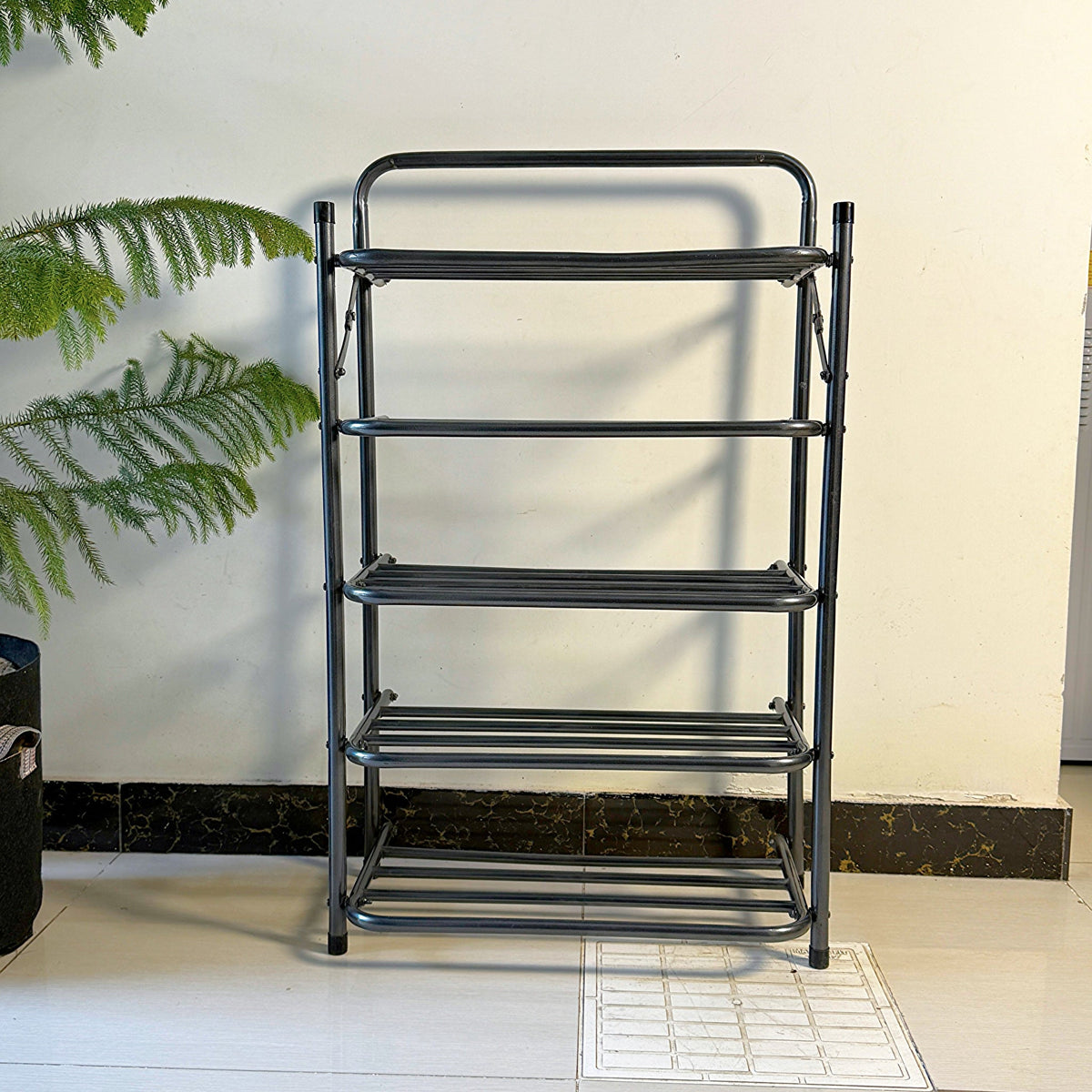 Foldable Metal Shoes Rack by Metallics Home with four shelves, black metal frame, and a compact design for space-saving stora