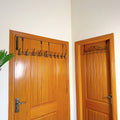 Set of 3 Over the Door Hangers by Metallics Home, featuring black metal hooks mounted on wooden doors for storage.