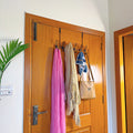Set of 3 Over the Door Hangers by Metallics Home, featuring scarves and a handbag hanging on a wooden door.