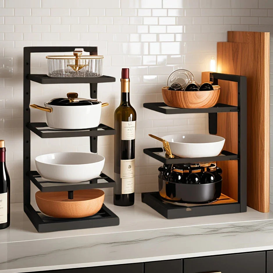 Floor Standing Kitchen Shelf by Metallics Home featuring black metal frame, wooden bowls, cookware, and wine bottles.