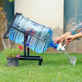 Swinging Bottle Rack by Metallics Home holds a large water bottle at an angle, allowing easy pouring into a glass.