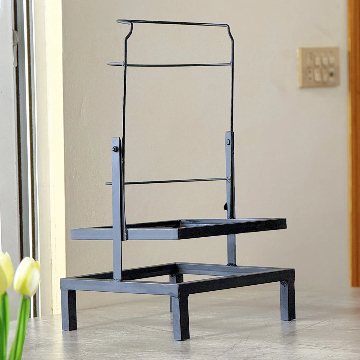 Swinging Bottle Rack by Metallics Home features a sturdy black metal frame with two levels for holding bottles.