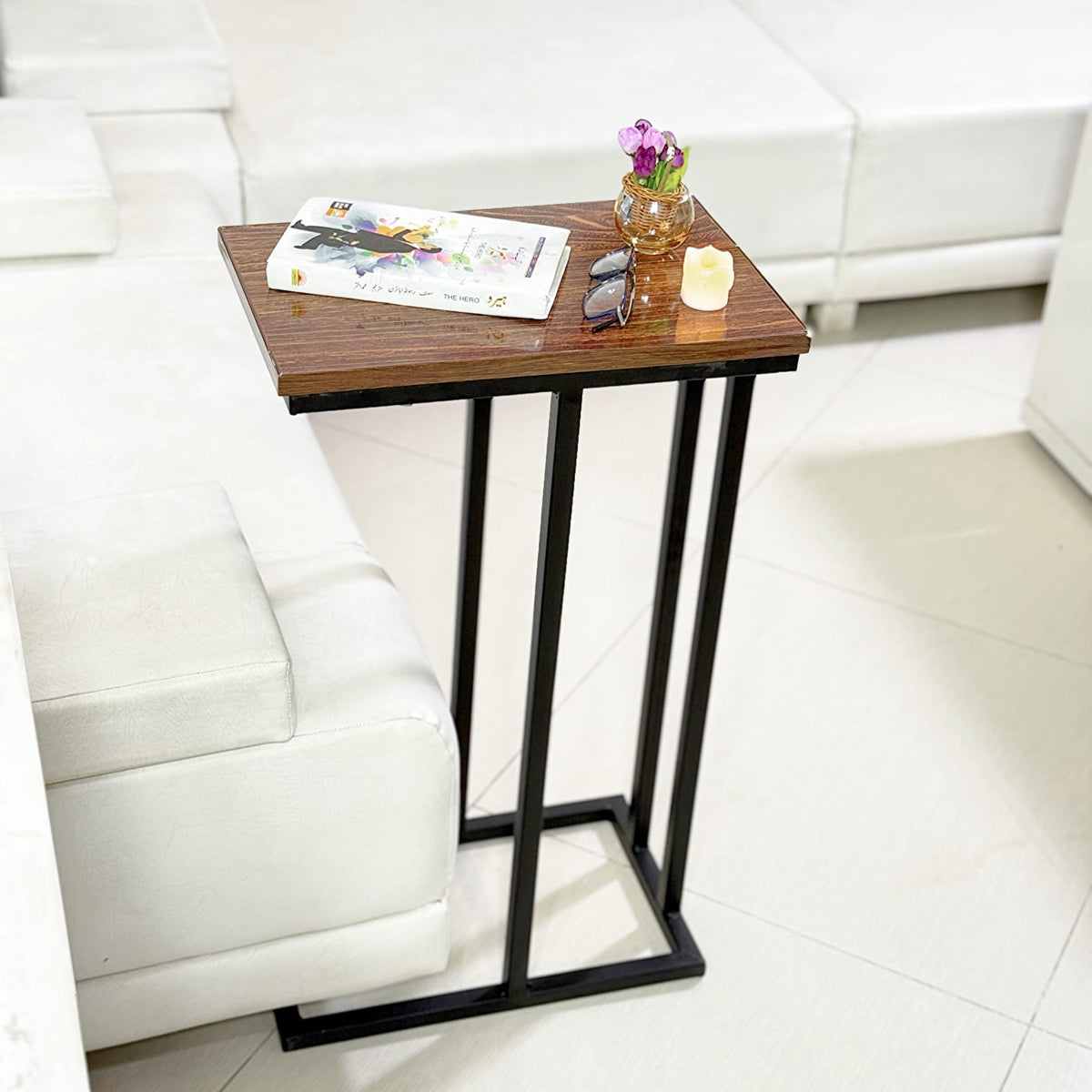 Wooden C Table and Side Table by Metallics Home featuring a sleek wooden top and black metal frame, placed beside a sofa.