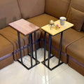 Wooden C Table and Side Table by Metallics Home featuring two tables with wooden tops and metal legs, placed beside a sofa.