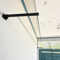 Foldable wall-mounted cloth drying stand with free rope, featuring a sleek black design for efficient drying space.