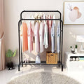 Metal Clothes Stand by Metallics Home featuring a black metal frame, side storage shelves, hooks, and hanging clothes.
