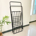 Premium Metal Folding Cloth Dryer Stand by Metallics Home, black, compact design, leaning against a wall with a plant nearby.